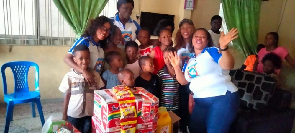 Children and TCV volunteers gathered around donated supplies